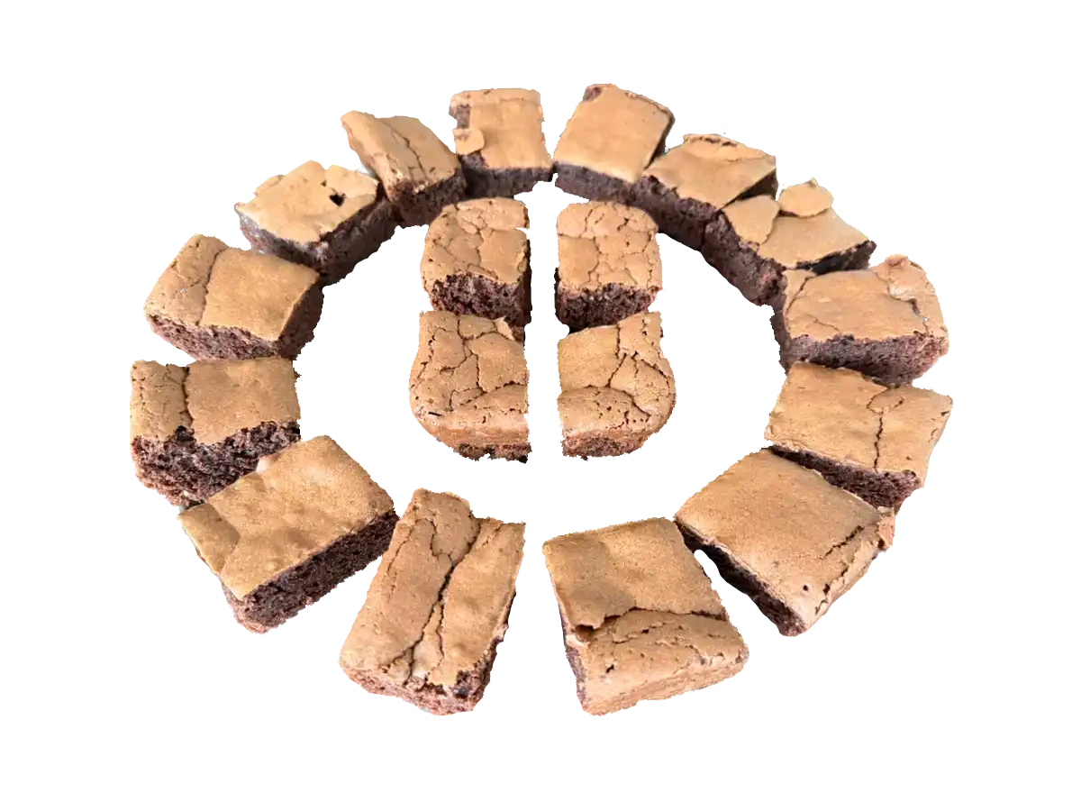 Chocolate brownies cut into pieces, arranged in a circle on a white background