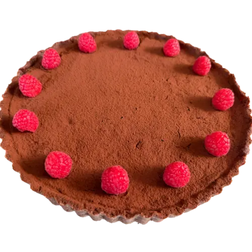 Chocolate tart with a cocoa-dusted filling and fresh raspberries on a dark tart crust