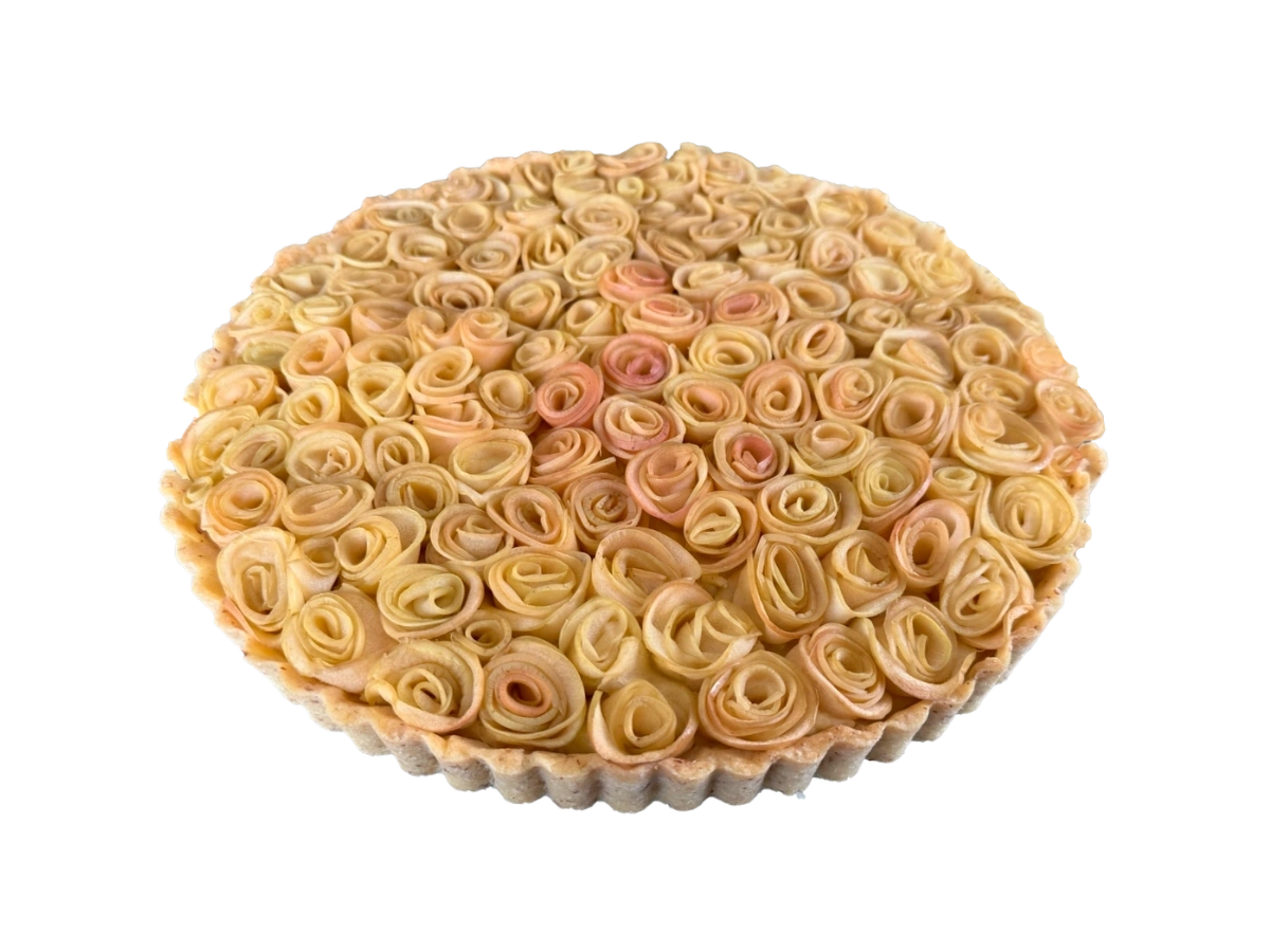 Apfelrosen-Tarte mit dicht gesetzten Apfelrosen aus feinen Apfelscheiben in einer runden Tarteform.