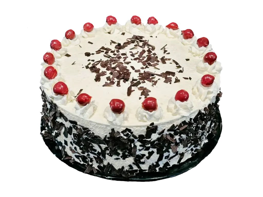 Black Forest cake with little whipped cream peaks, cherries and chocolate shavings on a cake stand