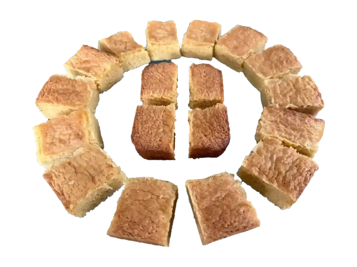 White chocolate blondies cut into pieces, arranged in a circle on a white background