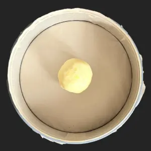 Baking pan prepared and shortcrust pastry shaped into a ball